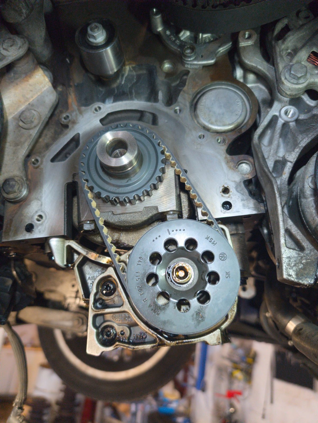 An engine with its front cover off in the Hi-Tech Garage workshop