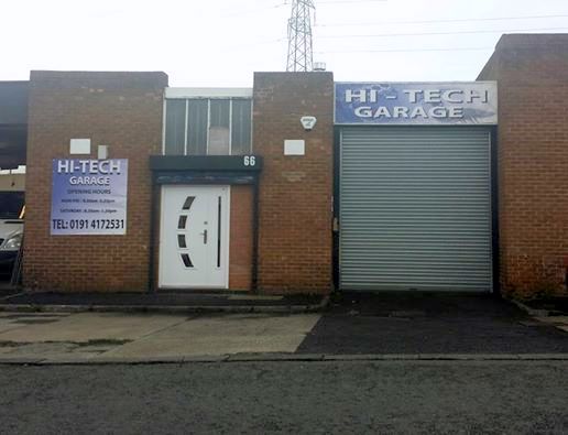 The front of Hi-Tech Garage at unit 66: brick unit with a white door and the garage sign over the roller shutter
